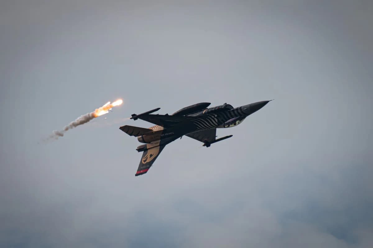 Fighter jet releasing flares in the sky