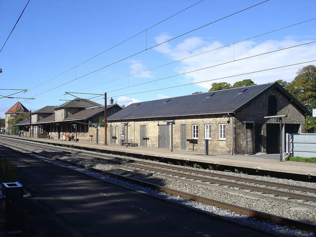 Sorø Station with platforms and tracks on a sunny day.