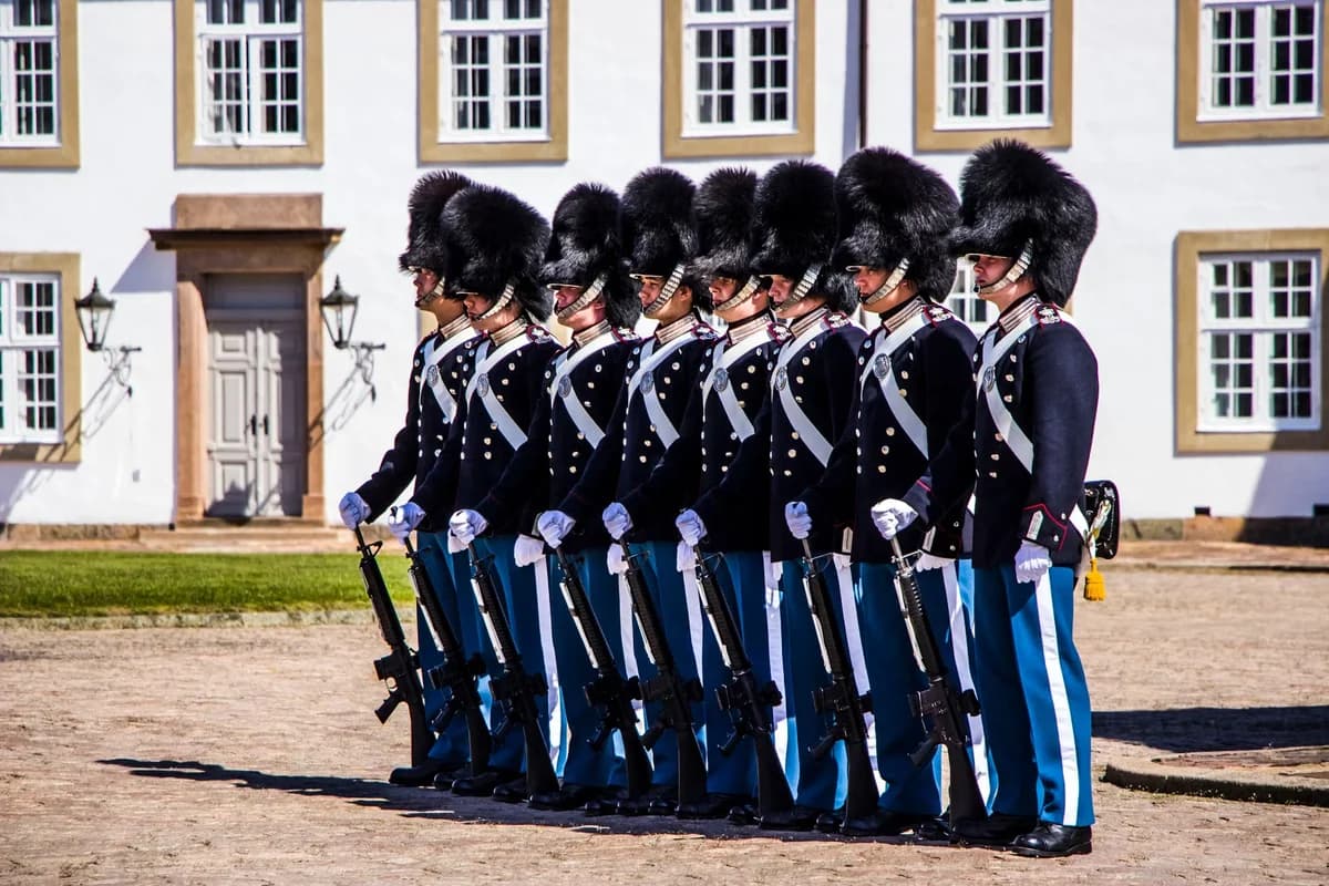 Royal Guards standing in formation outside Fredensborg Palace with rifles