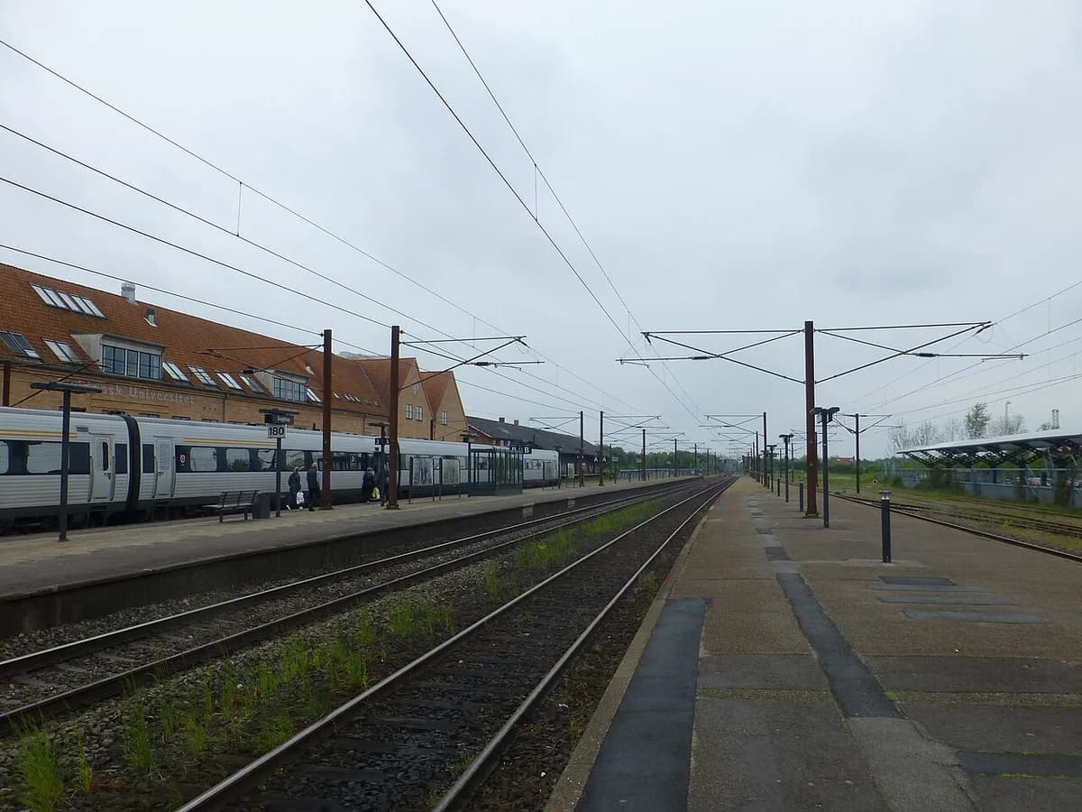 View of Slagelse Station platforms and tracks with a train on the left.