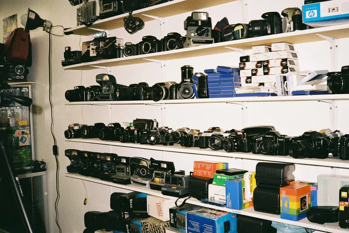 Shelves filled with vintage cameras and camera accessories in a photography shop