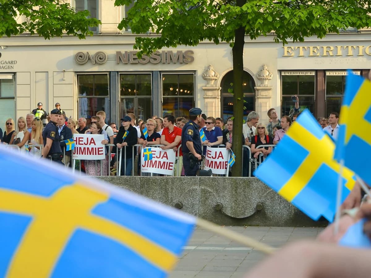 Supporters wave Swedish flags at a Jimmie Åkesson rally in Stockholm.