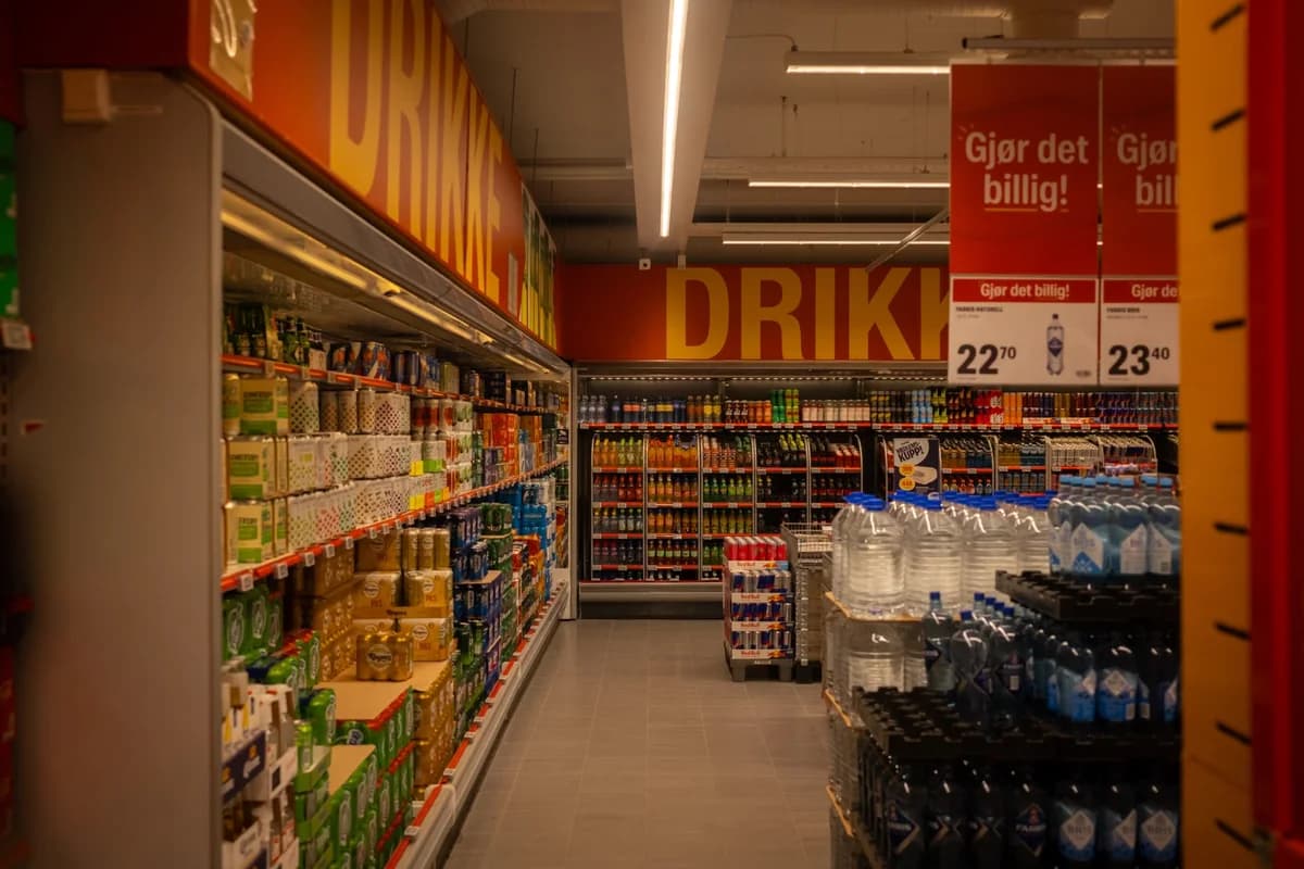 Colorful beverage aisle with promotional signs in supermarket